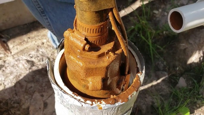 A borehole pump technician in Zimbabwe inspects and repairs a water pump beside a borehole, highlighting the challenges of pump breakdowns and the importance of maintenance for reliable water supply.